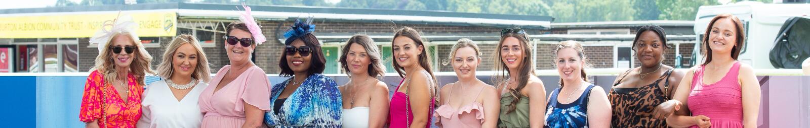 A large group of ladies dressed up for the race posing for a picture at Uttoxeter Racecourse
