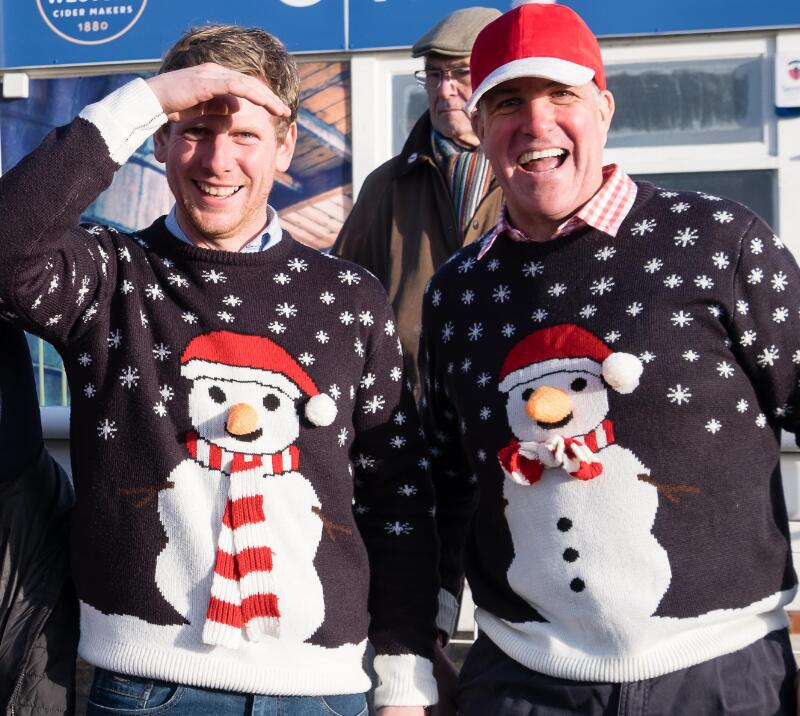 Two race goers in their Christmas jumpers at the races.