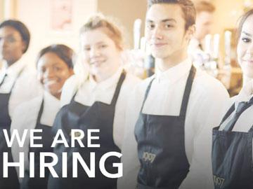 Bar staff lined up behind the bar counter for a photo.
