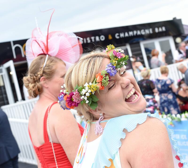 A race goer poses with a flower crown at Uttoxeter Races