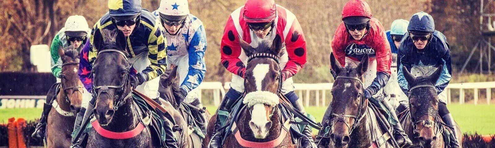 Group of jockeys racing at Uttoxeter Racecourse.