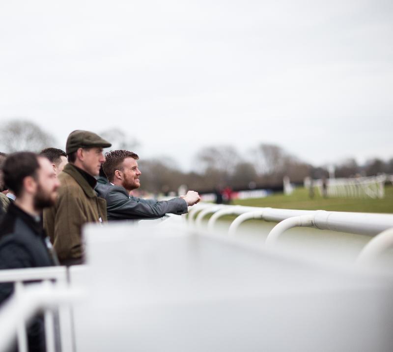 Racegoers standing next to the track at Uttoxeter Racecourse.