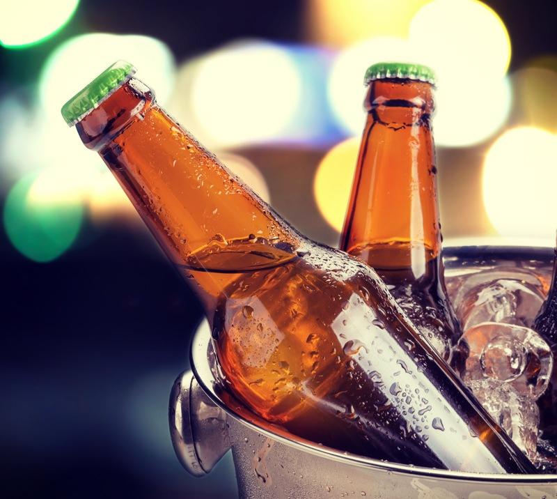 Ice cold bottles of beer in a bucket of ice