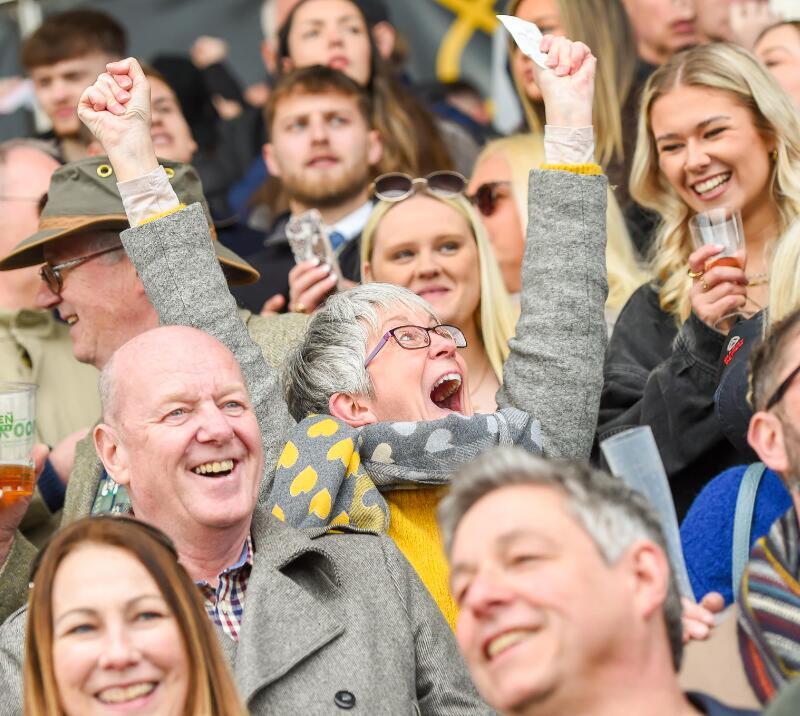 A race goer enthusiastically cheers in the crowd at Uttoxeter Races
