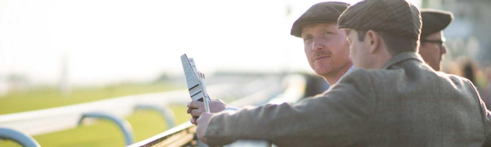 Well dressed gentlemen attend a day at the races